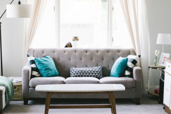 Brown and white wooden table beside sofa